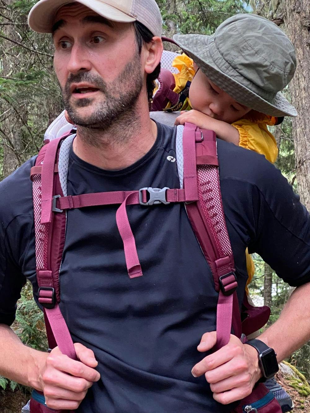 Rob's child asleep on his back during a hike