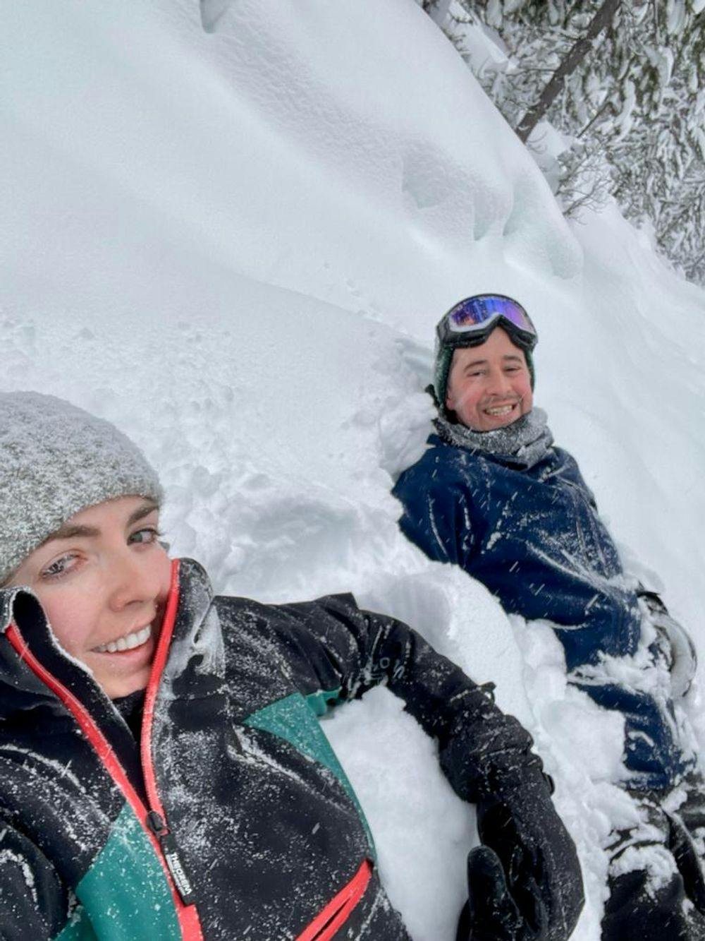 Ed and his partner sitting in the snow 