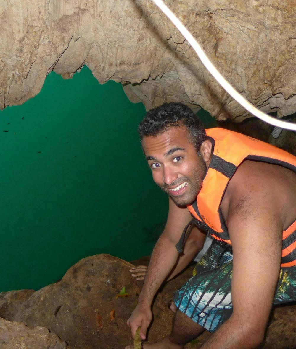 Ashwani smiling in a cave