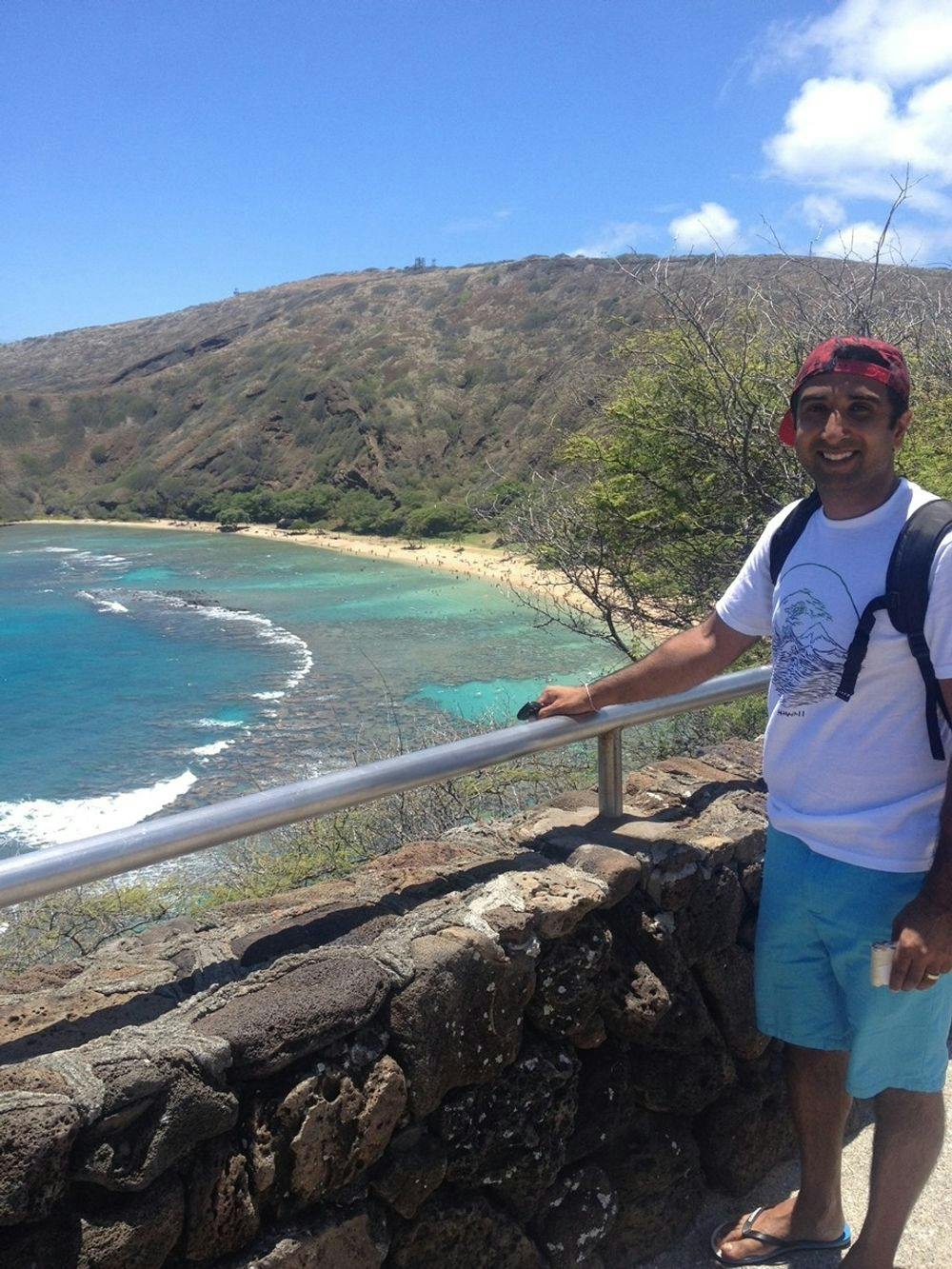 Nav in standing in front of a beach in Hawaii