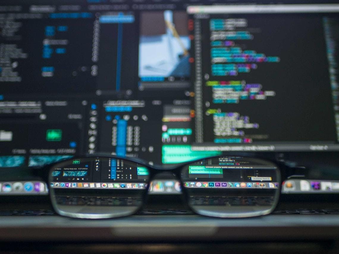 image of glasses in front of data model on a computer screen