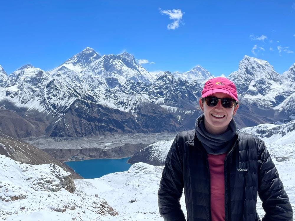 Kate smiling in front of snowy mountains
