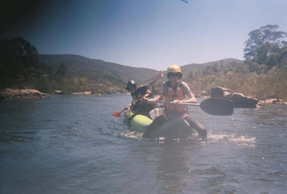 Jonah and a friend rafting in a grainy photo