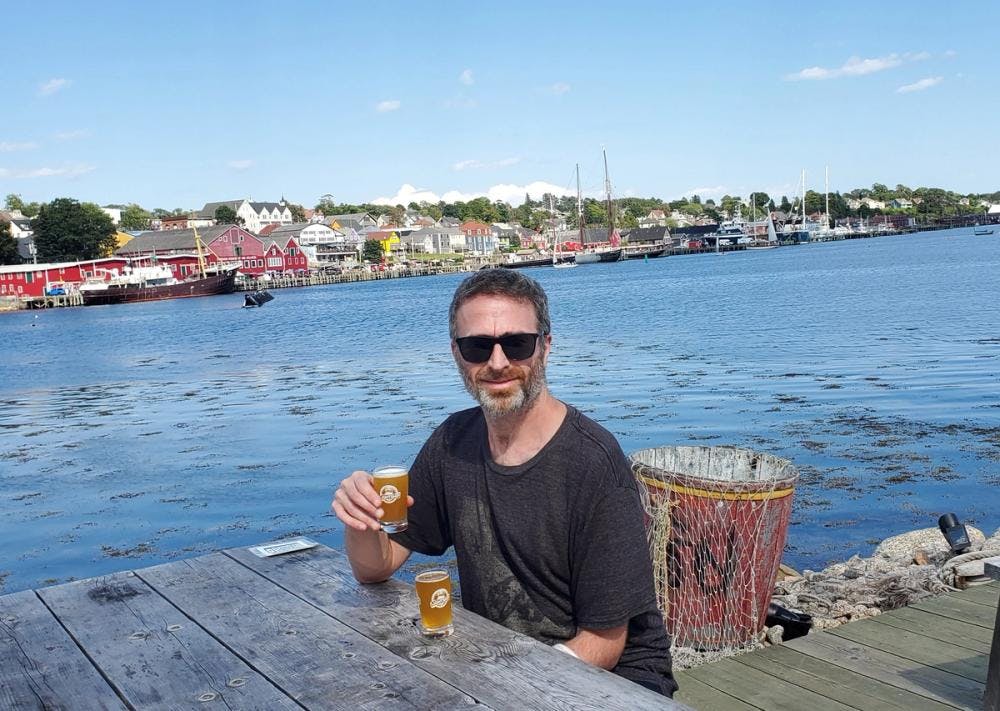 Earl drinking beer in a harbour